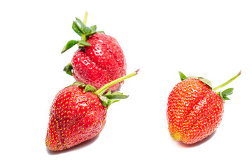 Strawberries with leaves isolated on a white background. Fresh red ripe berry waiting to be eaten.