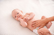 Baby massage. Masseur massaging tummy of baby during colic.
