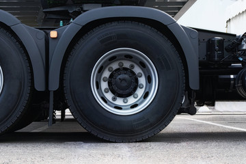 Truck tire, wheel of heavy duty semi truck, close up. Freight industry transport, wheels of modern truck.