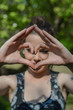 © sebastianosecondi - Heart shaped hands sign. Young woman doing a heart with both the hands. Happy girl giving satisfied and supportive hand gesture. Focus on the fingers.