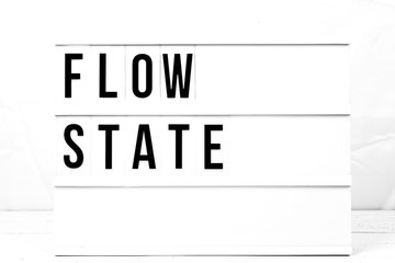 Wall Mural - Inspirational Flow State quote on vintage retro board. Concept. flat lay