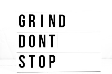 Wall Mural - Inspirational Grind Don't Stop quote on vintage retro board. Concept. flat lay