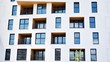 © Grand Warszawski - Contemporary residential building exterior in the daylight. Modern apartment buildings on a sunny day with a blue sky. Facade of a modern apartment building