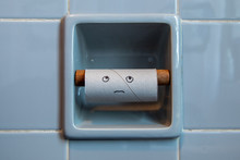 Empty Roll Of Toilet Paper With Sad Face In A Toilet Paper Holder
