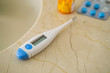 © Tetra Images - Thermometer and pills on stone surface