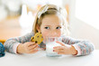© Jessica Peterson/Tetra Images - Girl eating milk and cookies