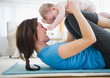 © Jamie Grill Photography/Tetra Images - Mother with baby daughter (6-11 months) practicing yoga