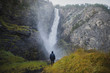 © Alexey Karamonov/Tetra Images - Young man standing on hill by waterfall