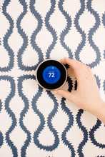 Hand Of Woman Adjusting Modern Smart Thermostat 