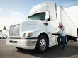 © Erik Isakson/Tetra Images - Truck driver entering truck