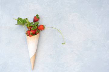 Wall Mural - Cone of paper with red straberries, leaves