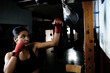 © Cavan Images - young woman practicing boxing at the gym