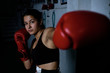 © Cavan Images - young woman practicing boxing at the gym