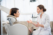 © Anna Kosolapova - A young woman complaining to her dentist in the dental clinic