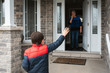 © Cavan Images - Social distance visit between young boy and his grandmother at home.