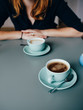 © Cavan Images - A woman and two cups of coffee in cafe