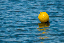 Close-up Of Yellow Buoy Floating On Water