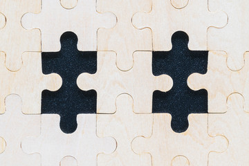 Close up wooden jigsaw puzzle pieces on black background