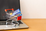 Fototapeta Konie - credit card and cart supermarket on wood table. shopping concept