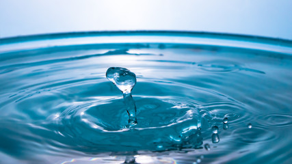 Wall Mural - Abstract an outbreak of water. Splash of water close-up. Frozen water drop photographed at high speed.Slow dripping of liquid with air bubbles. Nature backgrounds or Wallpaper.Frozen liquid splashes