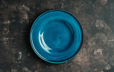 clean blue plate on the rustic background. selective focus. shot from above.