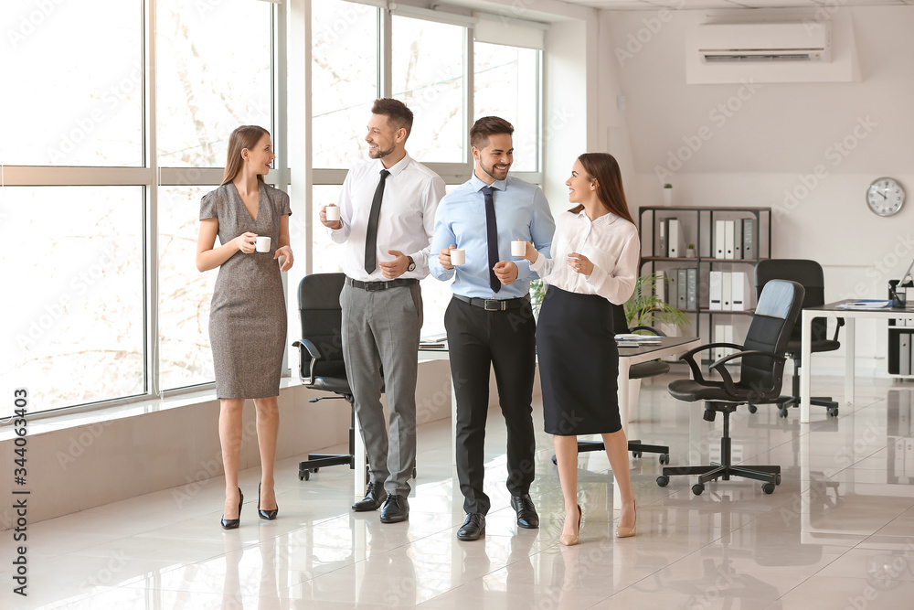 Colleagues drinking coffee in office