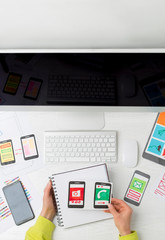 Web designer mobile phone application developer. Top view of the desktop of the creator of the sketch interface for smartphones.