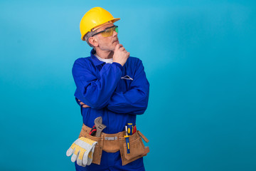 Wall Mural - construction worker or professional isolated on color background with tools