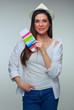 © Yuriy Shevtsov - Isolated portrait of smiling woman holding passport and ticket.