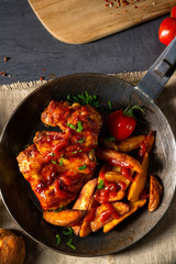 Wall Mural - Rustic chicken wings in honey with potato wedges