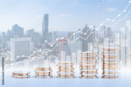Cuadros en Lienzo Finance, banking, and investment concept, double exposure of coins stack and city, with growing trend graph