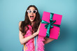 © Drobot Dean - Photo of delighted young woman in sunglasses posing with gift box