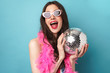 © Drobot Dean - Photo of joyful young woman smiling while posing with disco ball
