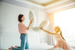 © Tom Wang - happy mother and daughter playing on the bed in the bedroom