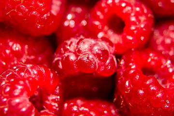 red raspberry background, juicy berries, raw food, closeup