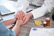 © thodonal - Doctor holding patient hand