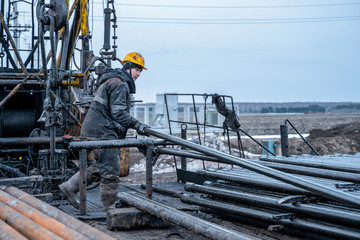 Wall Mural - Workover rig working on a previously drilled well trying to restore production through repair. Offshore oil rig worker prepare tool and equipment for perforation oil and gas well at wellhead platform.