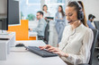 Portrait of female customer support or sales agent. Caller or receptionist phone operator working in call center.