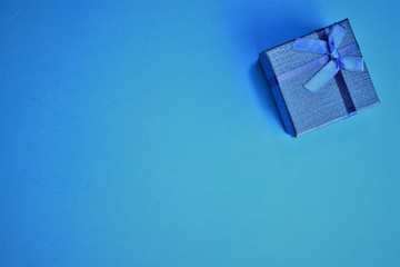 Gift box, on light blue background, space to write text