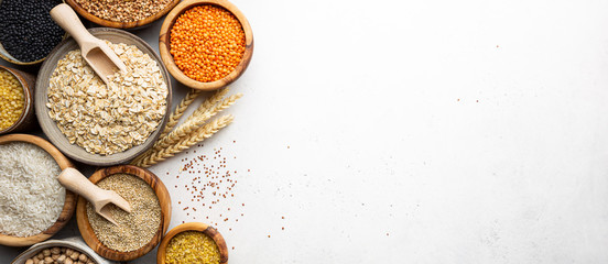 Organic products. Bowls with different gluten free grains on white background, top view