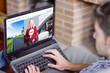 © GENETTICA - Man at home using laptop with driving school website on the screen
