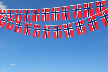 Wall Mural - Norway flag festive bunting hanging against a blue sky. 3D Render