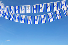 Israel Flag Festive Bunting Hanging Against A Blue Sky. 3D Render