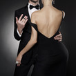 Conceptual photo of sexy elegant couple in the evening suit and dress.