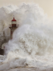 Fototapeta Stormy wave splash covering old lighthouse