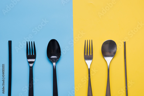 Comparison of metal silverware and plastic cutlery. View from above. Zero waste. Danger of plastic, but virus safe.