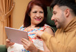 © PintoArt - son teaching his mother to use tablet. older people using technology