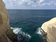 Cliffs In Sea Against Sky At Rosh Hanikra Grottoes National Park