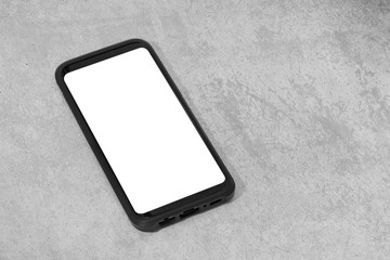 Smart phone with white screen isolated on textured concrete background. Mock up template. Copy space