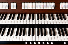 New Modern Pipe Organ Keyboards Front View. Simple Double Electronic Instrument Keyboard Seen From Above, Frontal Shot, Closeup. Church Sacral Music Classical Concert Background